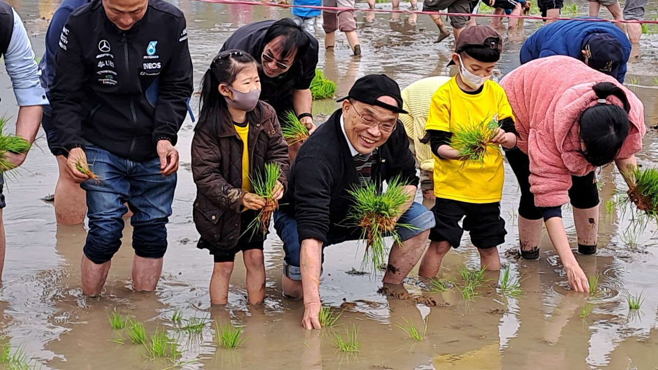 前行政院長蘇貞昌帶領小朋友走下水田，赤腳插秧，還指導小朋友要怎麼插秧。